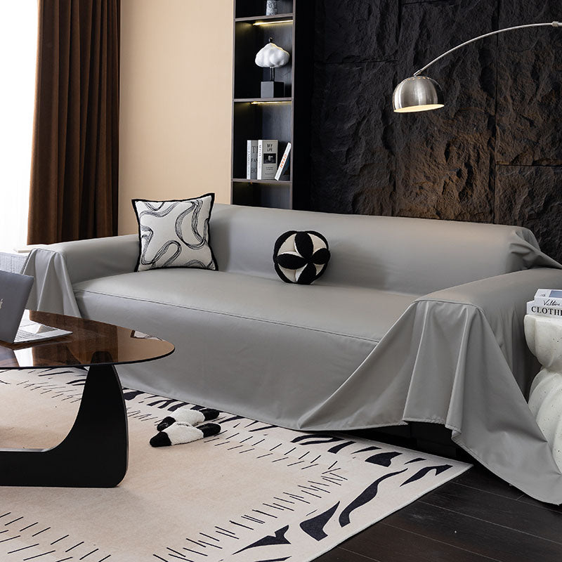 Faux leather sofa throw, Pearl grey, draped over a sofa