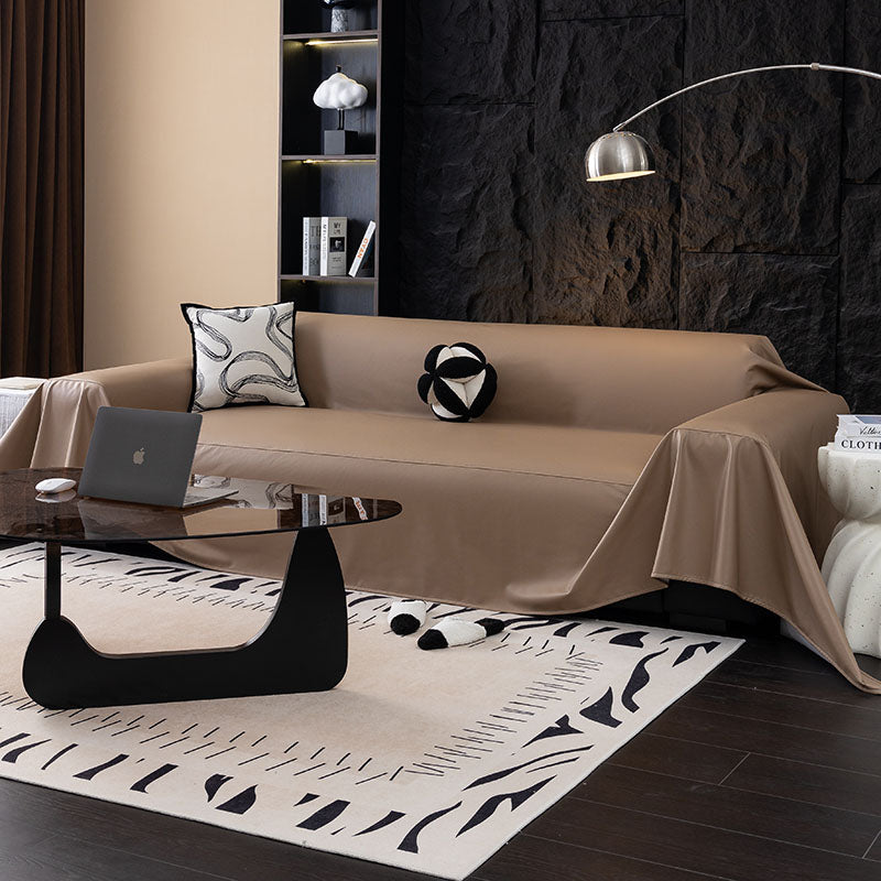Faux leather sofa throw, Taupe, draped over a sofa