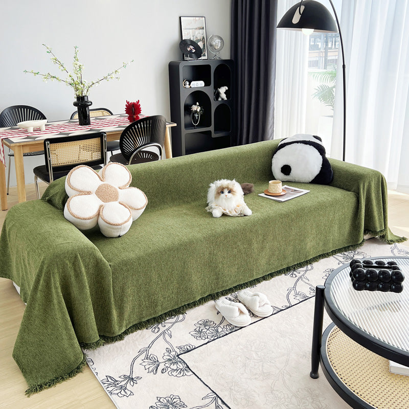 Woven sofa throw, Olive, draped over a sofa